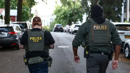 Federal agents walk near the scene where a man was shot by an Immigration and Customs Enforcement (ICE) officer during an operation in the Bronx borough of New York on October 8, 2026, according to local media and police. (Photo by CHARLY TRIBALLEAU / AFP)