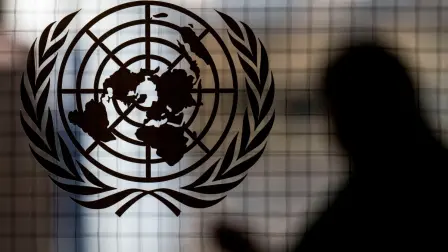 (FILES) A person walks past the UN logo at UN headquarters in New York City on February 8, 2024. All seven candidates to lead the United Nations received a vote of "discourage," effectively a veto, from a permanent UN Security Council member in the latest informal poll, a diplomat said October 16, 2026. October 16th's vote was the first time in six rounds of informal straw polling that Britain, China, France, Russia and the United States anonymously used colored straws to indicate vetoes, while the 10 elected members continued to use plain markers. (Photo by ANGELA WEISS / AFP)