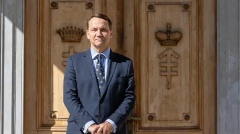 Poland's Minister of Foreign Affairs Radoslaw Sikorski waits for the arrival of his guest, the Chinese Foreign Minister, before their meeting at the representative center of the Ministry of Defense in Pruszkow, Poland, on September 15, 2025. (Photo by Wojtek RADWANSKI / AFP)