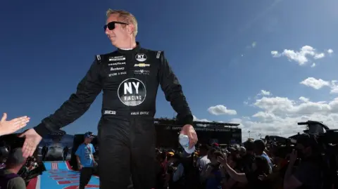 DAYTONA BEACH, FLORIDA - FEBRUARY 20: Greg Biffle, driver of the #44 Grambling State University Chevrolet, greets fans onstage during driver intros prior to the NASCAR Cup Series 64th Annual Daytona 500 at Daytona International Speedway on February 20, 2022 in Daytona Beach, Florida.   James Gilbert/Getty Images/AFP (Photo by James Gilbert / GETTY IMAGES NORTH AMERICA / Getty Images via AFP)