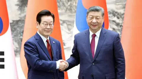 Chinese President Xi Jinping and South Korean President Lee Jae Myung shake hands at the Great Hall of the People in Beijing, China January 5, 2026. China Daily via REUTERS ATTENTION EDITORS - THIS PICTURE WAS PROVIDED BY A THIRD PARTY. CHINA OUT. NO COMMERCIAL OR EDITORIAL SALES IN CHINA.