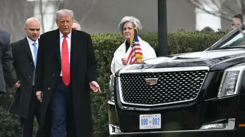 US President Donald Trump, accompanied by Director of White HouseOval Office Operations Walt Nauta (L) and Chief of Staff Susie Wiles, arrives at the White House after speaking at the House Republican Party (GOP) member retreat at the Kennedy Center in Washington, DC, on January 6, 2026. (Photo by Mandel NGAN / AFP)