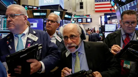 Traders work on the floor of the NYSE in New York - Traders work on the floor of the New York Stock Exchange (NYSE) in New York, U.S., October 4, 2017. REUTERS/Brendan McDermid