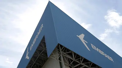 FILE PHOTO: The logo of Brazilian jets maker Embraer is seen on a factory in Sao Jose dos Campos - FILE PHOTO: The logo of Brazilian jets maker Embraer is seen on a factory in Sao Jose dos Campos, Brazil, December 23, 2017. REUTERS/Leonardo Benassatto/File photo - NARCH/NARCH30