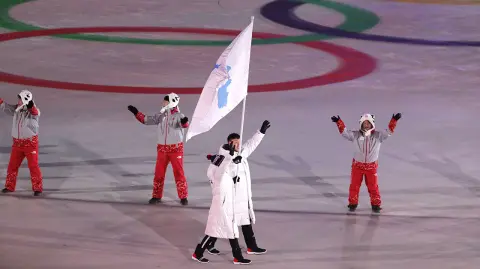 Pyeongchang 2018 Winter Olympics - Pyeongchang 2018 Winter Olympics â€“ Opening ceremony â€“ Pyeongchang Olympic Stadium - Pyeongchang, South Korea â€“ February 9, 2018 - Hwang Chung Gum and Won Yunjong of Korea carrie the unification flag during the opening ceremony. REUTERS/Kim Kyung-Hoon