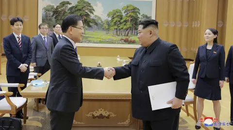 North Korean leader Kim Jong Un shakes hands with Chung Eui-yong in this photo released by North Korea