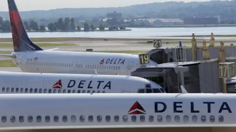 FILE PHOTO: Delta Airlines planes are parked at gates at Ronald Reagan Washington National Airport in Washington - NARCH/NARCH30