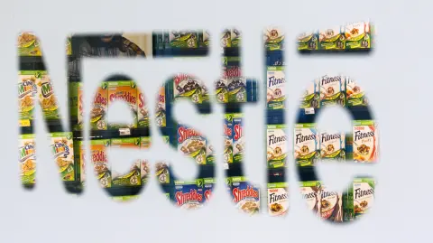 File picture shows Nestle cereal boxes through a logo in the company supermarket at the Nestle headquarters in Vevey - Nestle cereal boxes are pictured through a logo in the company supermarket at the Nestle headquarters in Vevey, in this file picture taken February 17, 2011. Nestle, the world