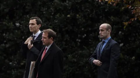 IMMIG-WHITEHOUSE - From left: Senior adviser Jared Kushner, Oval Office operations director Jordan Karem and senior adviser Stephen Miller follow President Trump as he walks from the Oval Office to Marine One on the South Lawn of the White House on Nov. 26, 2018. MUST CREDIT: Washington Post photo by Jabin Botsford.