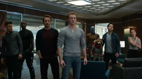 This image released by Disney shows, from left, Jeremy Renner, Don Cheadle, Robert Downey Jr., Chris Evans, Karen Gillan, the character Rocket, voiced by Bradley Cooper, Paul Rudd and Scarlett Johansson in a scene from "Avengers: Endgame." (Disney/Marvel Studios via AP) - AP PROVIDES ACCESS TO THIS THIRD PARTY PHOTO SOLELY TO ILLUSTRATE NEWS REPORTING OR COMMENTARY ON FACTS DEPICTED IN IMAGE; MUST BE USED WITHIN 14 DAYS FROM TRANSMISSION; NO ARCHIVING; NO LICENSING; MANDATORY CREDIT.