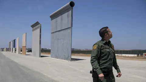 CALIF-BORDER - Border Patrol Public Affairs Officer Vincent Pirro looks at border wall prototypes in a sector of the border wall in San Diego, California, on April 25, 2018. MUST CREDIT: Washington Post photo by Carolyn Van Houten
