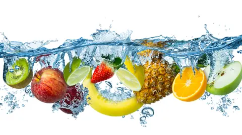 fresh multi fruits splashing into blue clear water splash healthy food diet freshness concept isolated white background