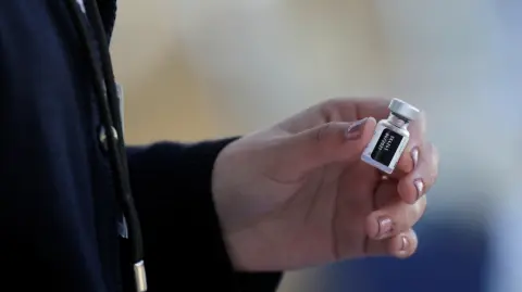 A medical worker holds a dose of the Pfizer-BioNTech COVID-19 vaccine at the Regional Military Specialty Hospital, in San Nicolas de los Garza