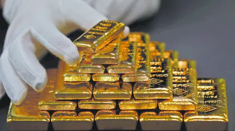 FILE PHOTO: An employee sorts gold bars in the Austrian Gold and Silver Separating Plant 
