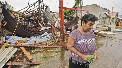 Martha Sanchez reacts while walking in front of her souvenir store that was destroyed when Hurricane Grace slammed into the coast with torrential rains, in Costa Esmeralda, near Tecolutla, Mexico August 21, 2021.   REUTERS/Oscar Martinez