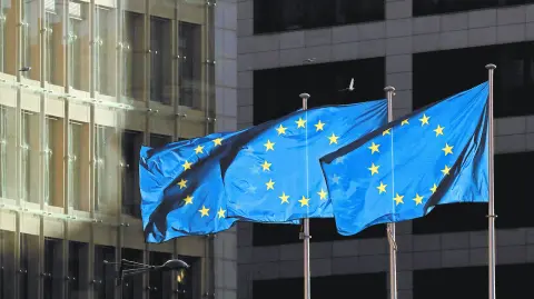 FILE PHOTO: European Union flags fly outside the European Commission headquarters in Brussels