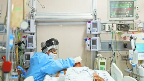 SENSITIVE MATERIAL. THIS IMAGE MAY OFFEND OR DISTURB    A medical worker in protective suit treats a patient suffering from the coronavirus disease (COVID-19) in an intensive care unit at Hospital Juarez de Mexico in Mexico City, Mexico October 29, 2020. REUTERS/Carlos Jasso-SMOUT
