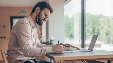 Young student with laptop indoors