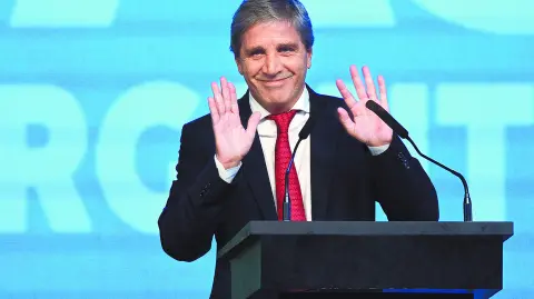 Argentina's Economy Minister Luis Caputo gestures during the Conservative Political Action Conference (CPAC) in Buenos Aires on December 4, 2024. (Photo by JUAN MABROMATA / AFP)