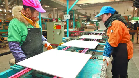 JIUJIANG CHINA-Dec 4, 2012:Jiujiang light industrial enterprises Nobel Ceramics Co., Ltd. production workshop, the workers are building ceramic tile products, products exported to Southeast asia.