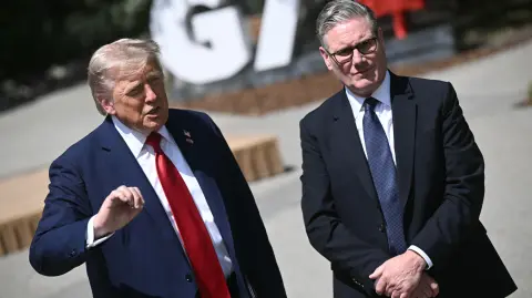 US President Donald Trump (L) and British Prime Minister Keir Starmer speak to reporters after meeting during the Group of Seven (G7) Summit at the Pomeroy Kananaskis Mountain Lodge in Kananaskis, Alberta, Canada on June 16, 2025. (Photo by Brendan SMIALOWSKI / AFP)