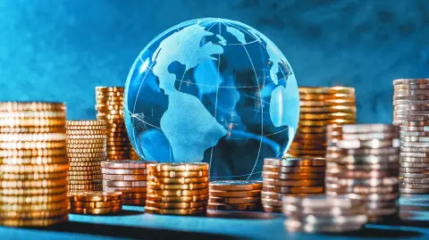 Globe and stack with coins. Money makes the world go round