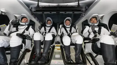 This picture provided by NASA shows, from L to R, Roscosmos cosmonaut Kirill Peskov, NASA astronauts Nichole Ayers, Anne McClain, and Japan Aerospace Exploration Agency (JAXA) astronaut Takuya Onishi inside the SpaceX Dragon Endurance spacecraft onboard the SpaceX recovery ship Shannon shortly after having landed in the Pacific Ocean off the coast of San Diego, California, on August 9, 2025. McClain, Ayers, Onishi, and Peskov are returning after seven months in space as part of Expedition 73 aboard the International Space Station (ISS). (Photo by Keegan BARBER / NASA / AFP) / RESTRICTED TO EDITORIAL USE - MANDATORY CREDIT "AFP PHOTO /  NASA / KEEGAN BARBER" - NO MARKETING NO ADVERTISING CAMPAIGNS - DISTRIBUTED AS A SERVICE TO CLIENTS