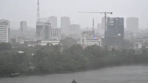 La ciudad costera de Vinh amaneció bajo un diluvio el lunes, con la mayoría de sus comercios cerrados y resguardados con bolsas de arena.