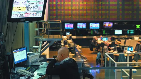 A broker looks at a screen at the Buenos Aires Stock Exchange in the financial district of Buenos Aires on August 20, 2019 after Argentina's President Mauricio Macri swore Hernan Lacunza in as the country's new economy minister. Lacunza made stabilizing the country's battered currency his top priority Tuesday, while still pledging to meet commitments made to the International Monetary Fund, which is sending a team to Buenos Aires. (Photo by Juan MABROMATA / AFP)