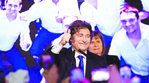 Argentina's President Javier Milei gestures after the La Libertad Avanza party won the midterm election, which is seen as crucial for Milei's administration after U.S. President Donald Trump warned that future support for Argentina would depend on Milei's party performing well in the vote, in Buenos Aires, Argentina, October 26, 2025. REUTERS/Cristina Sille