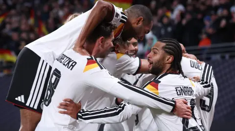 Germany's players celebrate after midfielder #09 Assan Ouedraogo scored his team's sixth goal during the FIFA World Cup 2026 European qualification Group A football match between Germany and Slovakia, at the Red Bull Arena in Leipzig, eastern Germany on November 17, 2025. (Photo by Ronny HARTMANN / AFP)