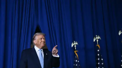 US President Donald Trump arrives to deliver remarks at McDonald's Impact Summit in Washington, DC on November 17, 2025. (Photo by Brendan SMIALOWSKI / AFP)