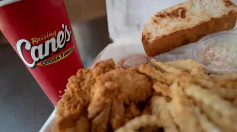 CHICAGO, ILLINOIS - JUNE 30: Chicken is served at a Raising Cane's restaurant on June 30, 2025 in Chicago, Illinois. Raising Canes overtook KFC to become the nation's third-largest chicken chain behind Chick-fil-A and Popeyes. (Photo Illustration by Scott Olson/Getty Images) (Photo by SCOTT OLSON / GETTY IMAGES NORTH AMERICA / Getty Images via AFP)