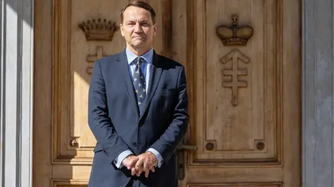 Poland's Minister of Foreign Affairs Radoslaw Sikorski waits for the arrival of his guest, the Chinese Foreign Minister, before their meeting at the representative center of the Ministry of Defense in Pruszkow, Poland, on September 15, 2025. (Photo by Wojtek RADWANSKI / AFP)