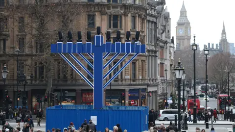 Protective fencing surrounds a Hanukkah menorah candle installation, two days after a deadly attack at Sydney's Bondi Beach Hanukkah event, in Trafalgar Square, London, Britain, December 15, 2025. REUTERS/Toby Melville