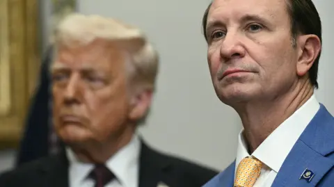 (FILES) (L-R) US President Donald Trump and Louisiana Governor Jeff Landry attend an event with Hyundai executives in the Roosevelt Room of the White House in Washington, DC, March 24, 2025. Denmark said on December 22, 2025 it would summon the US ambassador after President Donald Trump appointed a special envoy to Greenland who immediately vowed to make the Danish autonomous territory "a part of the US". Since returning to the White House in January, Trump has repeatedly said the US needs the resource-rich Arctic island for security reasons, and has refused to rule out using force to secure it. On December 21, Trump appointed Louisiana governor Jeff Landry as special envoy to Greenland. Danish Foreign Minister Lars Lokke Rasmussen said on December 22 he was "deeply angered" by the move and warned Washington to respect Denmark's sovereignty, with the EU later offering its "full solidarity". (Photo by Brendan SMIALOWSKI / AFP)