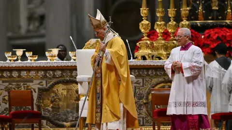 A general view shows a nview of the basilica interior as Pope Leo XIV leads the Christmas Eve mass at St Peter's Basilica in the Vatican on December 24, 2025. (Photo by Andreas SOLARO / AFP)