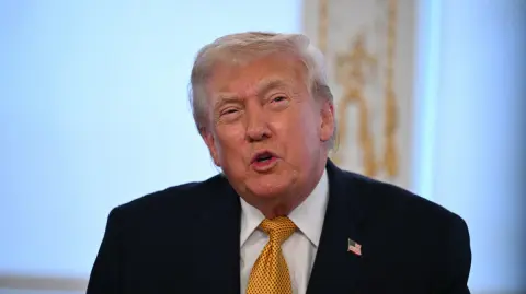 US President Donald Trump participates in calls to US service members, on Christmas Eve, from the Mar-a-Lago club in Palm Beach, Florida, December 24, 2025. (Photo by ANDREW CABALLERO-REYNOLDS / AFP)