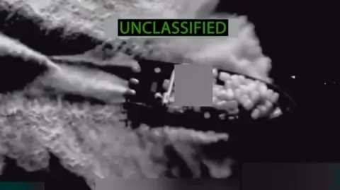 Imagen desclasificada y publicada por el Comando Sur del Ejército de Estados Unidos de una embarcación supuestamente ligada al narcotráfico y bombardeada por las fuerzas estadounidenses.