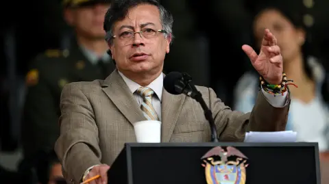(FILES) Colombia's President Gustavo Petro delivers a speech during the commemoration of the 134th anniversary of the National Police and the promotion of officers at the General Santander Police Academy in Bogota on November 13, 2025. Colombian President Gustavo Petro, a left-wing leader, announced on December 29, a historic 23.7% increase in the minimum wage for 2026, the largest of this century, (Photo by Raul ARBOLEDA / AFP)