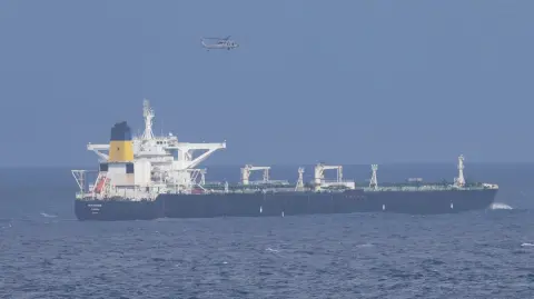 This image posted on US Homeland Security's X account shows the Centuries crude oil tanker, last docked in Venezuela, as it is apprehended by the US Coast Guard on December 20, 2025. The United States "apprehended" an oil tanker off Venezuela on December 20, the latest salvo in a pressure campaign against Caracas, the US government said.It was the second time in two weeks that US forces have interdicted a tanker in the region, and comes days after President Donald Trump announced a blockade of "sanctioned oil vessels" heading to and leaving Venezuela. (Photo by Handout / US Department of Homeland Security / AFP) / RESTRICTED TO EDITORIAL USE - MANDATORY CREDIT "AFP PHOTO / HOMELAND SECURITY'S X ACCOUNT " - NO MARKETING NO ADVERTISING CAMPAIGNS - DISTRIBUTED AS A SERVICE TO CLIENTS