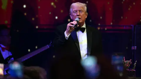 US President Donald Trump speaks during the New Year's Eve Party at his Mar-a-Lago residence in Palm Beach, Florida on December 31, 2025. (Photo by Jim WATSON / AFP)