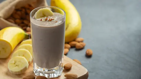 Banana almond smoothie on dark background