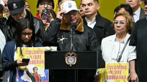 Colombias President Gustavo Petro sings the national anthem during the March for Sovereignty and Democracy against US President Donald Trumps threats to Petro at Bolivar Square in Bogota on January 7, 2026. Donald Trump held his first phone call with Colombian counterpart Gustavo Petro on January 7, the foreign ministry in Bogota said, days after the US President threatened him with military action. (Photo by Luis ACOSTA / AFP)