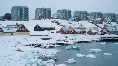 (FILES) Apartment buildings and houses are pictured in Nuuk, Greenland, on March 24, 2025. Greenland's Prime Minister Jens-Frederik Nielsen said on January 14, 2026 now was "not the time" to talk about the Arctic island's future independence and jeopardise its right to self-determination, as US President Trump ramps up threats to take control of it. (Photo by Juliette PAVY / AFP)