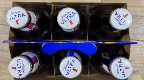 LARKSPUR, CALIFORNIA - DECEMBER 16: In this photo illustration, a six-pack of Michelob Ultra is displayed at a BevMo store on December 16, 2024 in Larkspur, California. According to data from Draftlines Technologies, the Anheuser-Busch InBev beer Michelob Ultra has overtaken Bud Light as the most popular beer on tap in the United States. (Photo illustration by Justin Sullivan/Getty Images) (Photo by JUSTIN SULLIVAN / GETTY IMAGES NORTH AMERICA / Getty Images via AFP)