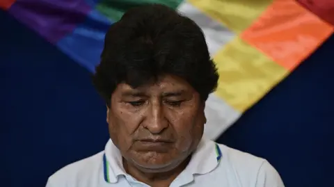 Bolivia's former president (2006-2019) Evo Morales looks on during a meeting ahead of voting in the presidential runoff election in Villa 14 de Septiembre, Chapare region, Cochabamba department, Bolivia, on October 19, 2025. Bolivians head to the polls to choose between right-wing candidates Jorge 'Tuto' Quiroga and Senator Rodrigo Paz, both promising change as the country of some 12 million people sees the end of two decades of socialist rule. (Photo by ERNESTO BENAVIDES / AFP)