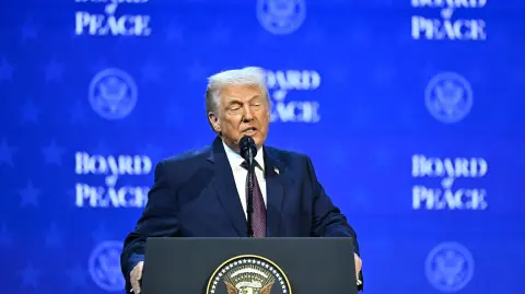 US President Donald Trump speaks at the "Board of Peace" meeting during the World Economic Forum (WEF) annual meeting in Davos on January 22, 2026. US President Donald Trump will show off his new "Board of Peace" at Davos on January 22, 2026 burnishing his claim to be a peacemaker a day after backing off his own threats against Greenland. Originally meant to oversee the rebuilding of Gaza after the war between Hamas and Israel, the board's charter does not limit its role to the Strip, and has sparked concerns that Trump wants it to rival the United Nations. (Photo by Fabrice COFFRINI / AFP)