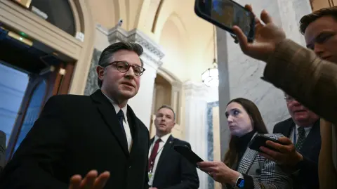 US Speaker of the House Mike Johnson, Republican from Louisiana, speaks with reporters as he arrives at the US Capitol in Washington DC, on February 2, 2026. US House Speaker Mike Johnson expressed confidence on February 1 that he has the votes to end by Tuesday a partial government shutdown triggered by the Trump administration's violent immigration sweeps in Minneapolis. The government entered the shutdown Saturday as a funding deadline passed without Congress approving a 2026 budget. The impact so far appears to have been minimal. (Photo by ANDREW CABALLERO-REYNOLDS / AFP)