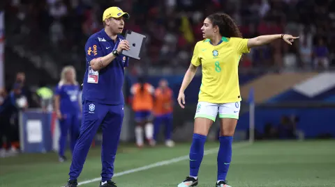 A member of the coaching staff for Brazils womens football team gives instructions to Brazil's midfielder #08 Angelina during the women's friendly football match between France and Brazil at the Stade des Alpes in Grenoble, central-eastern France, on June 27, 2025. (Photo by Alex MARTIN / AFP) / The erroneous mention[s] appearing in the metadata of this photo by Alex MARTIN has been modified in AFP systems in the following manner: [A member of the coaching staff for Brazils womens football team] instead of [Brazil's women football head coach Arthur Elias]. Please immediately remove the erroneous mention[s] from all your online services and delete it (them) from your servers. If you have been authorized by AFP to distribute it (them) to third parties, please ensure that the same actions are carried out by them. Failure to promptly comply with these instructions will entail liability on your part for any continued or post notification usage. Therefore we thank you very much for all your attention and prompt action. We are sorry for the inconvenience this notification may cause and remain at your disposal for any further information you may require.
